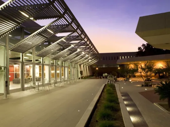 The outside of the law school and the courtyard in front of it, highlighted by the sunset.