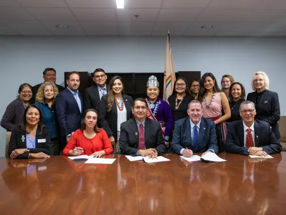 Representatives from the University of Arizona and the Navajo Nation gathered in a group to sign a memorandum of agreement establishing a new fellowship program