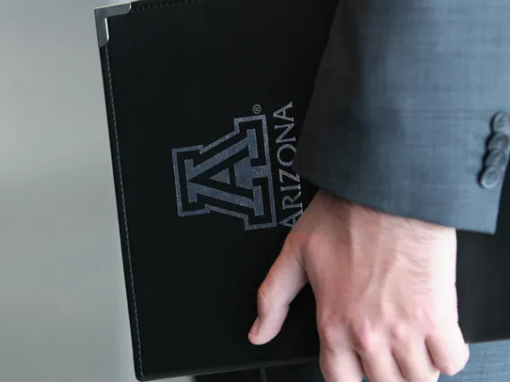 University of Arizona padfolio in student's hand