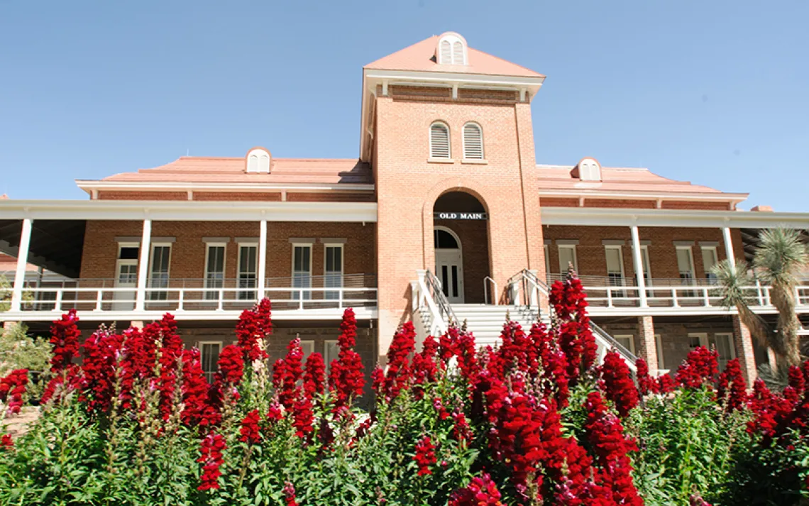 Image of Old Main on a sunny day with flowers