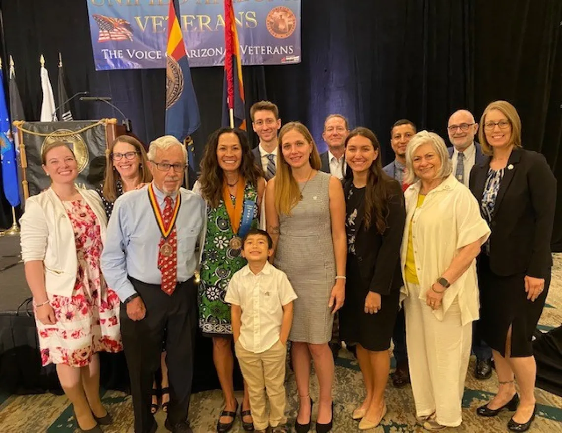 Kristine Huskey surrounded with current and former students, professors and family after receiving award