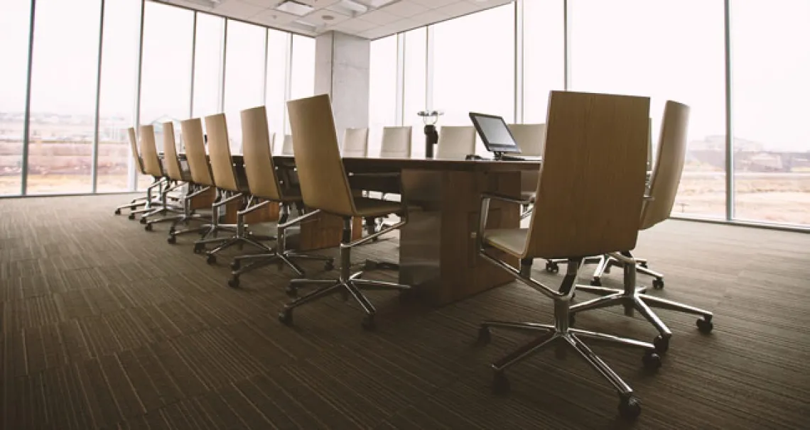 Conference room with long table and office chairs