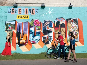 Greetings from Tucson mural with University of Arizona Law students walking in front