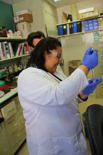 A woman working in a science lab